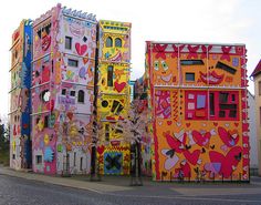 several brightly painted buildings on the side of a road