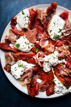 a white plate topped with meat and cheese