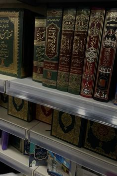 rows of books on shelves in a store, with arabic writing and other decorative items