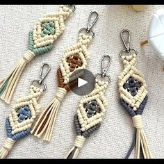 four macrame keychains with tassels hanging from them on a table