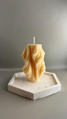 a candle sitting on top of a white tray