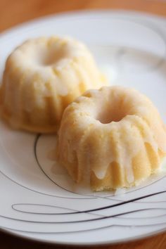 two donuts sitting on top of a white plate