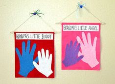 two handprinted signs hanging on a wall next to each other with the words grandpa's little buddy and grandma's little angel