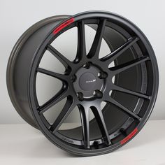 a black wheel is shown with red lettering on the front and back rims, which are