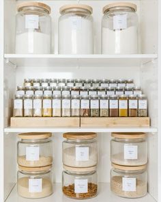 shelves filled with jars and spices on top of each other