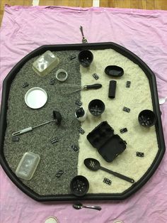 there is a tray that has various items on it and the bottom half shows an assortment of utensils