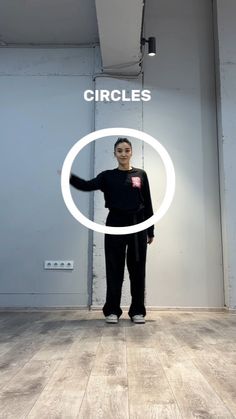 a woman standing in front of a white circle with the words circles above her head