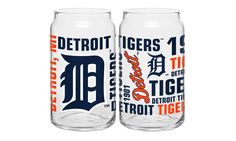 two detroit tigers beer glasses sitting next to each other on a white background with orange and blue lettering