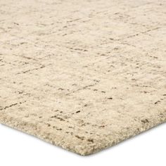 an area rug with white and beige colors on the top, in front of a white background