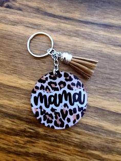 a leopard print keychain with the word mama on it and a tassel