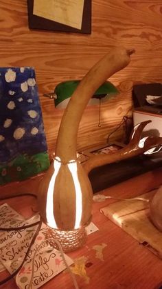 a wooden table topped with a vase filled with fake antlers