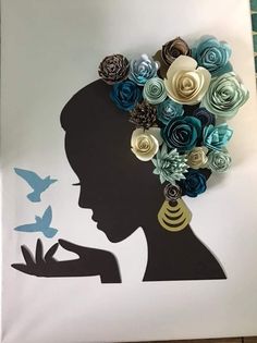 a woman's silhouette with paper flowers in her hair