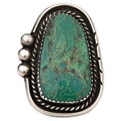 This vintage sterling silver ring features a green turquoise natural stone accented by braiding details and three silver beads on one side. It is set on a double shank. This ring is a size 5.75 but can be resized for a small fee. It weighs 12.8 grams. The ring measures approximately 1.5" x 1.25". It is a fabulous statement ring! Condition: Very good. Typical of wear and age. Turquoise Jewelry Western, Vintage Turquoise Ring, Vintage Sterling Silver Rings, Western Jewelry, Fancy Jewelry, Vintage Turquoise, Green Turquoise, Vintage Ring, Ring Vintage