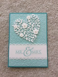 a wedding card with a heart made out of flowers