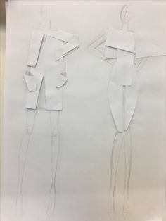 two paper cutouts of women standing next to each other on a piece of white paper