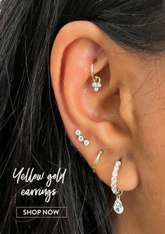 a close up of a person's ear with three different types of piercings