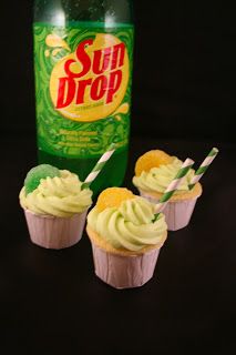 three cupcakes are next to a can of sun drop