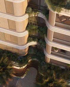 an aerial view of two tall buildings with plants growing on them