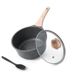 an empty frying pan with a wooden spoon next to it