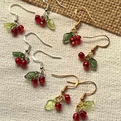 🍒Lover of cherries or just super cute food accessories? Then you're definitely in the right place! 😉 Wear these earrings to a cherry picking event, cherry blossom festival, picnic, farmers market, party, for cherry dessert baking, a trip to Door County, WI, or throw them on just for fun 🥰 They're sure to get lots of compliments! These cherry earrings are the perfect accessory for every season - spring, summer, fall, or winter! These adorable and lightweight beaded cherry earrings are 100% handmade. PLEASE HANDLE WITH CARE!❤️ MATERIALS 💎Glass E Beads 🌿Acrylic Leaf Beads 🔗Assorted Metal Findings ✨Hypoallergenic 925 Silver-Plated Copper Earring Hooks (silver or gold) 💌Clear Silicone Earring Backs (provided with each earring!) DIMENSIONS (approx, per individual earring) 📏Length - 3 cm Fall Bead Jewelry, Cherry Beaded Earrings, Beaded Cherry, Whimsical Earrings, Cherry Blossom Earrings, Jewelry Market, Fall Bead, Cherry Picking, Wire Wrap Jewelry Designs