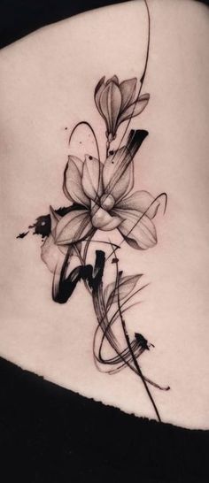 a woman's stomach with some flowers on the side and one flower in the middle