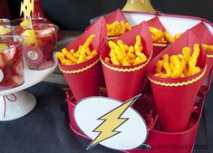 a table topped with red buckets filled with food