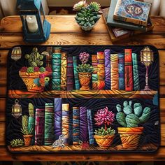 two bookshelves with cactus and succulents painted on them are sitting on a table