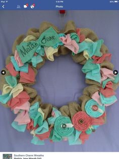 a wreath made out of burlocks and fabric with the words mother's home on it