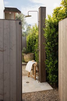 an outdoor shower in the middle of a garden