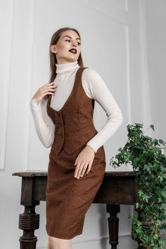 This brown checkered wool suit is handmade by Tauri Look designers from the highest quality Italian wool. A semi-formal women's Suit with a waistcoat gives freedom to move, while the lace in the back allows you to adjust the tightness of the vest. Together with a pencil shape skirt, it allows you to create an image of an attractive business woman. This classic women's suit with a vest is ideal for you if, when the weather gets cold, you instantly start looking for clothes that are not only stylish but also guarantee warmth and coziness.  When you wear this formal women's suit, you will perfectly fit the norms of business etiquette. You can easily match the skirt with another black, grey, or even solid green blazer, too. The waistcoat looks great not only with dark color skirts but also whe Semi Formal Skirt, Suit With Waistcoat, Semi Formal Skirts, Suit With Vest, Dinner Outfits Summer, Semi Formal Mujer, Formal Suits For Women, Waistcoat Suit, Checkered Vest