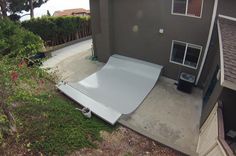 an overhead view of a house with a car ramp on the side of the house