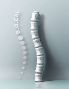 a white vase sitting on top of a table next to a sign that says bocaat