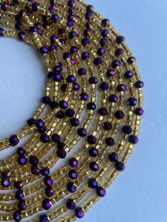 Single Strand Waist Bead Guezon, featuring a luxurious combination of gold glass crystal beads with elegant purple crystal glass bead accents. Why You'll Love It: Luxurious Shine: Gold glass crystal beads provide a radiant and opulent sparkle. Elegant Accents: Purple crystal glass beads add a touch of sophistication and regal beauty. Perfect Fit: The adjustable single strand design ensures comfort and a secure fit for all body types. Cultural Beauty: This piece reflects the rich heritage of Ivor Ivorian Culture, Purple Waist Beads, Cultural Beauty, Traditional Beauty, Waist Beads, Purple Crystal, Purple Crystals, Gold Glass, Glass Crystal