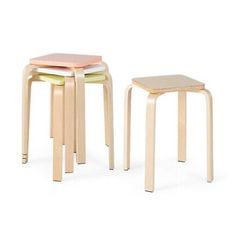 three wooden stools with different colors and sizes on each side, one in the shape of a square