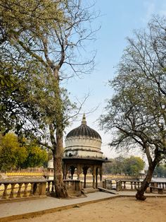 a gazebo in the middle of a park surrounded by trees