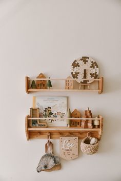 two wooden shelves with toys on them and a clock hanging from the wall next to each other