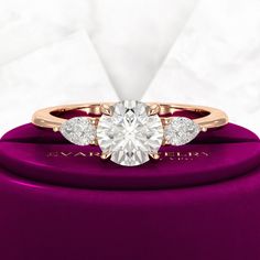 an engagement ring with three diamonds on it in a purple velvet jewelry box that says, i love you