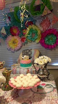 a table topped with lots of cakes and desserts