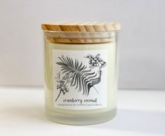 a white candle with a wooden lid and label that says contemporary coconut