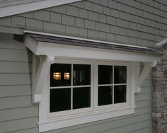 an image of a house that has windows on the side of it and brick wall