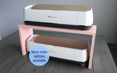 two printer machines sitting side by side on a wooden table with the words more color options available