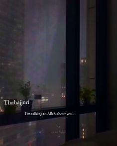 a window with the words thaahjud on it in front of a cityscape