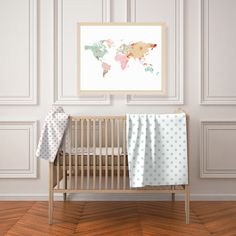 a baby's room with a crib and a map on the wall above it