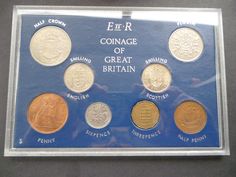 the coin collection is displayed in a clear case