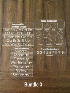 three clear plastic numbers on top of a wooden table with the words, abc and d