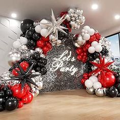 the balloon arch is decorated with black, white and red balloons