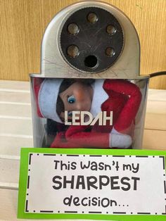 an elf is sitting in a tin can with a sign that reads, ledah this was'l my sharpest decision