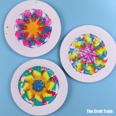 three paper plates with different colored designs on them