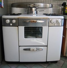 an old fashioned stove in the corner of a kitchen