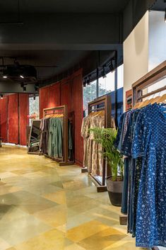 the inside of a clothing store with clothes hanging on racks